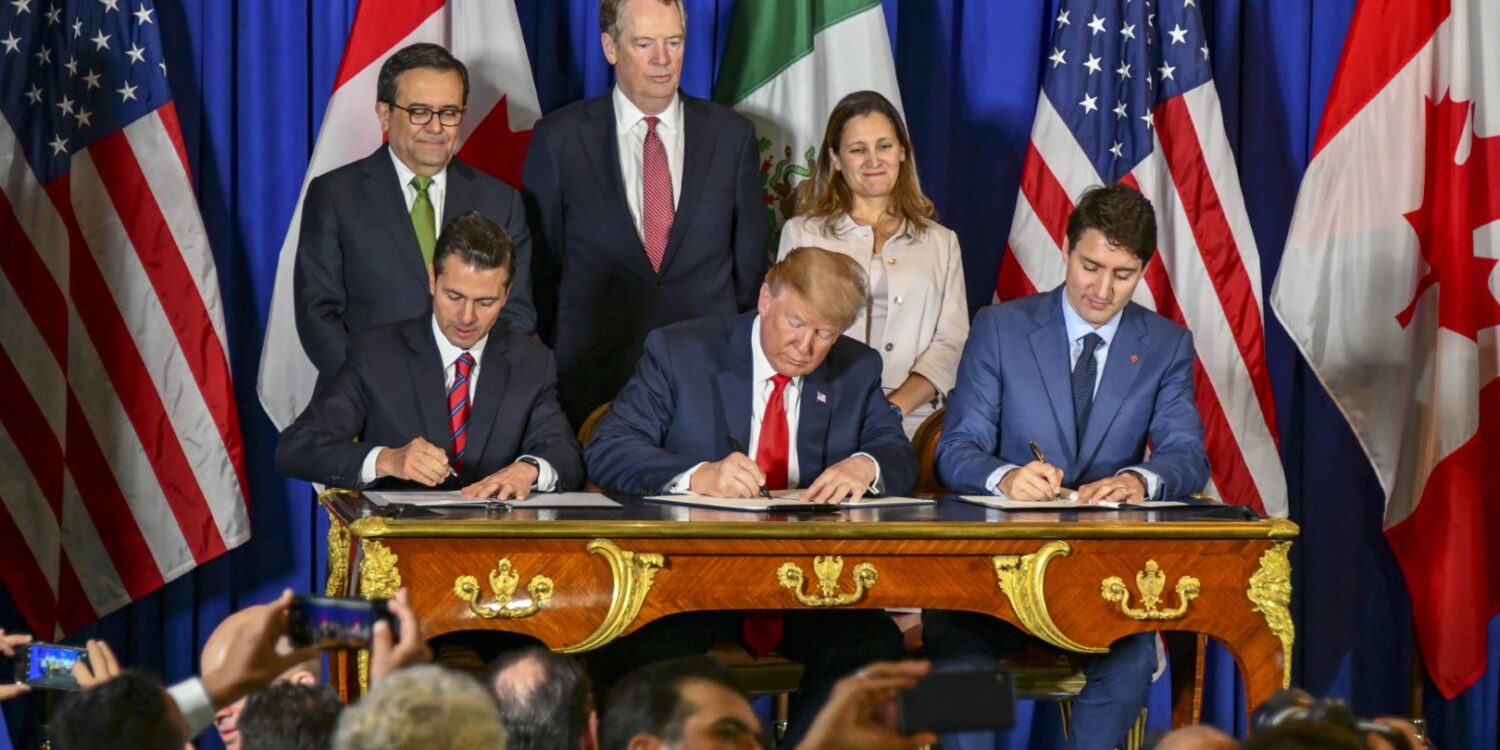 Trudeau signing CUSMA alongside US President Donald Trump and Mexican President Nieto, 2018