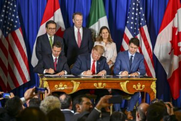 Trudeau signing CUSMA alongside US President Donald Trump and Mexican President Nieto, 2018